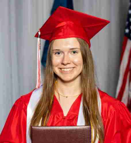 Falcon View Online graduate wearing a red cap and gown holding a diploma, highlighting successful high school completion in Minnesota.