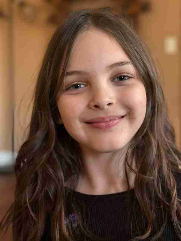 Smiling elementary-aged Falcon View Online student, highlighting personalized and supportive online learning in Minnesota.