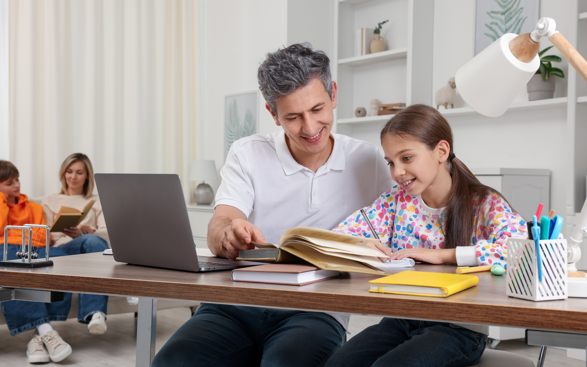 Minnesota parent helping elementary student with schoolwork at home while learning through Falcon View Online, a tuition-free K-12 public online school.