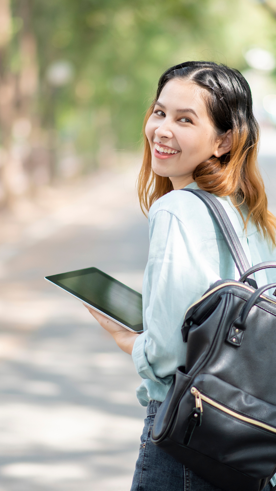 Student holding a tablet and backpack representing school counseling and student support services at Falcon View Online in Minnesota.