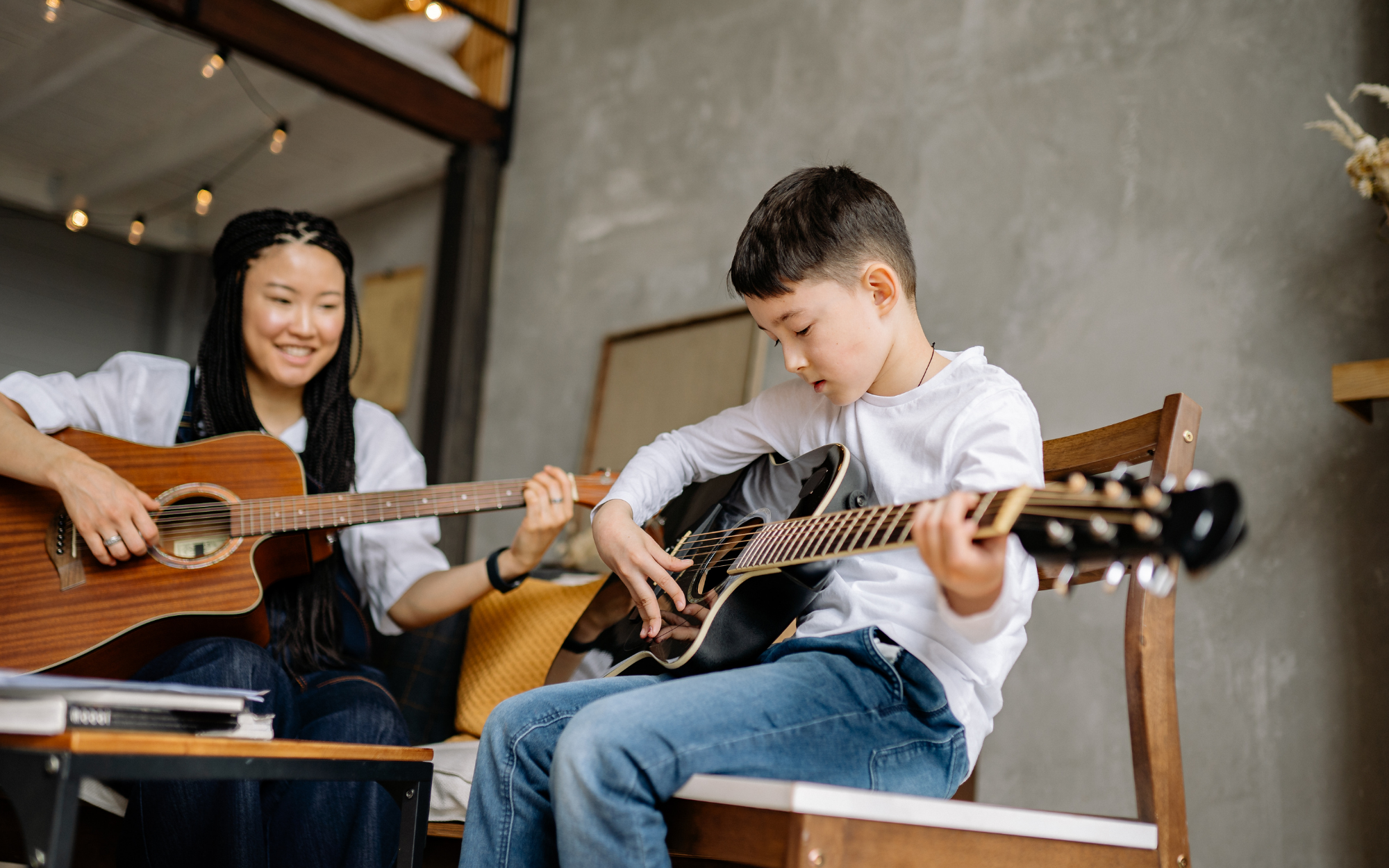 Student learning guitar at home while balancing flexible online school schedule, Falcon View Online Minnesota personalized learning.
