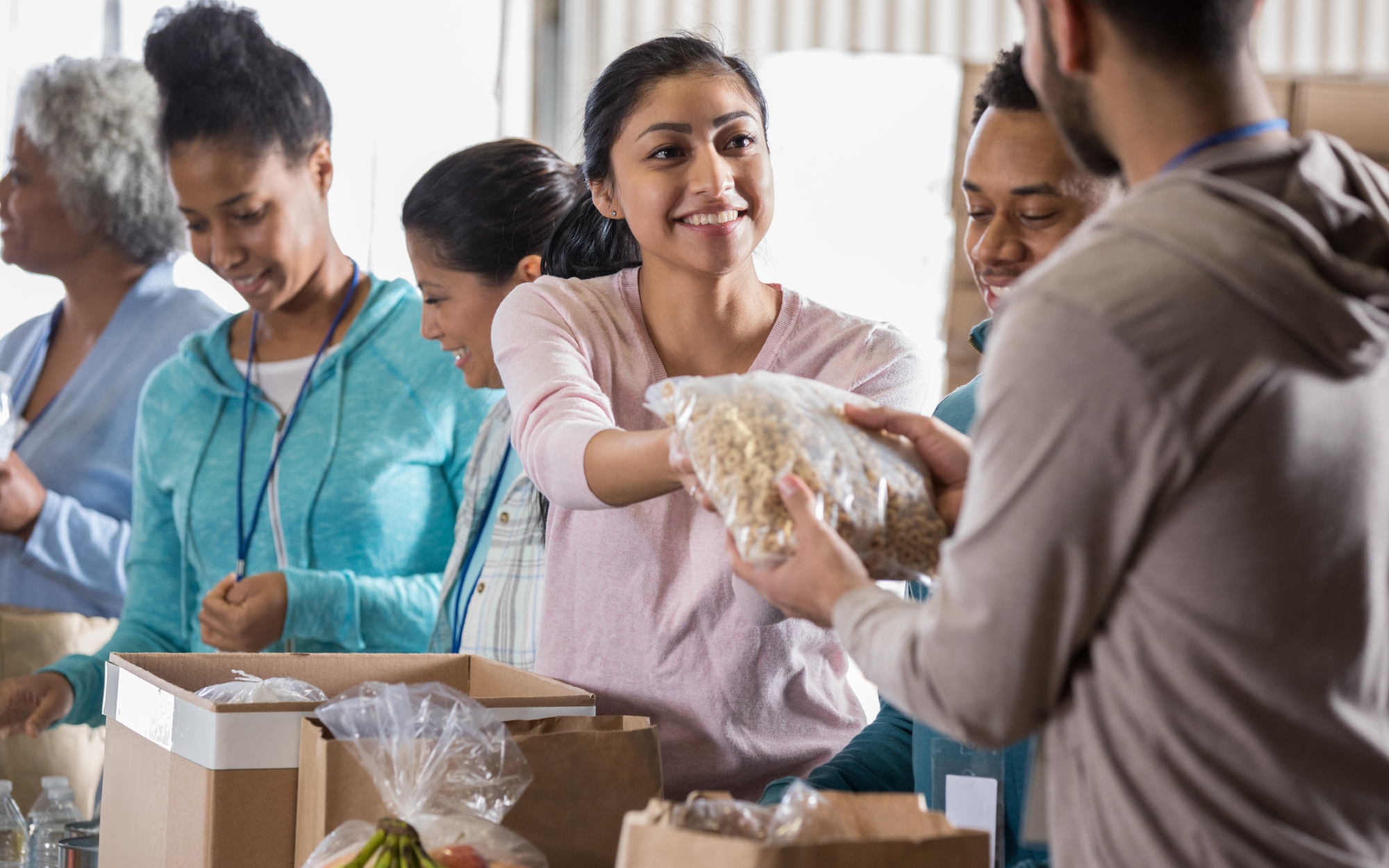 Students volunteering together at a community food distribution event, representing leadership and service opportunities for online school students in Minnesota.