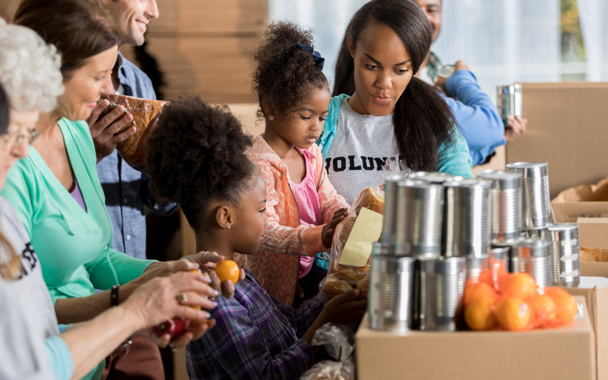 Students volunteering together at a community food distribution event, representing leadership and service opportunities for online school students in Minnesota.