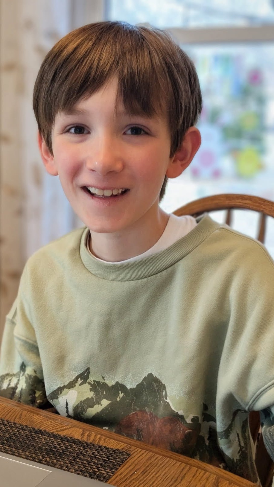 Falcon View Online student smiling during online learning at home, representing student success and enrollment opportunities in Minnesota.